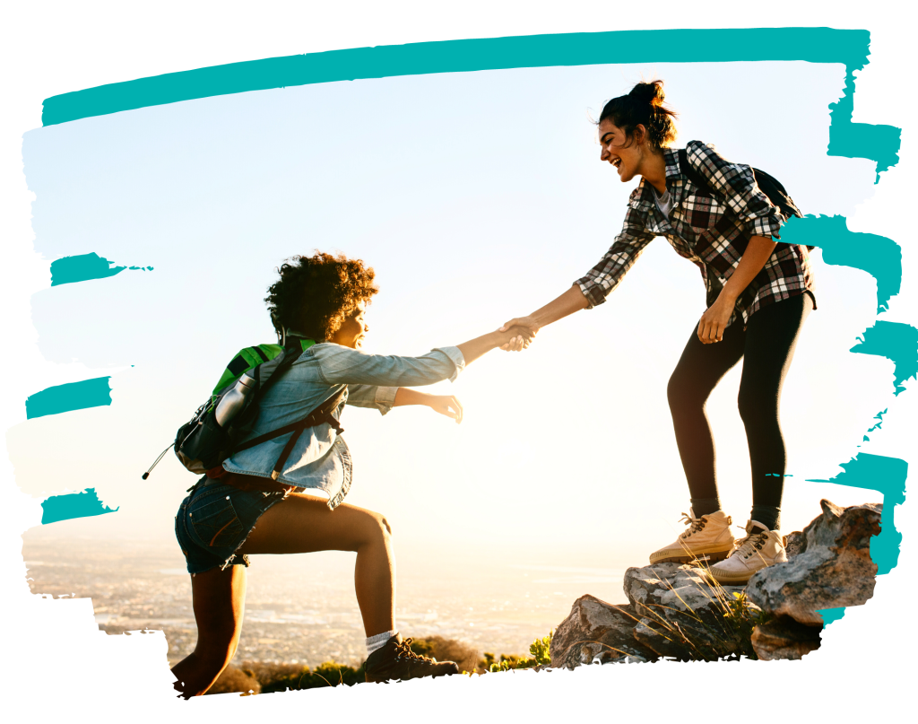 young adults helping each other on a hike